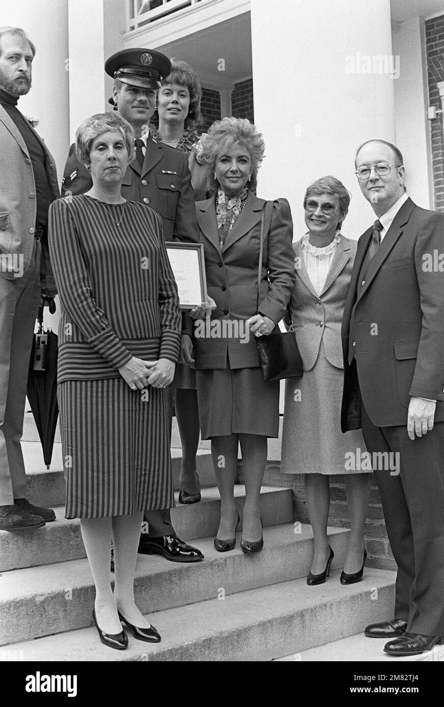 AIRMAN First Class Mark R. Puffer, the recipient of the United Service Organization (USO) C. Haskell Small Award, poses with his family and other award winners. Sarah Brady, wife of White House Press Secretary James Brady, and actress Elizabeth Taylor shared the USO`s 'Woman of the Year' award. Base: Washington State: District Of Columbia (DC) Country: United States Of America (USA) Stock Photo